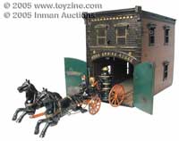 Ives Firehouse and pumper --A classic American toy, this Ives cast-iron Fire Engine House with horse-drawn pumper