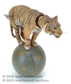 wonderful clockwork tiger made by French automata manufacturer Roullet et Descamps balances on a star-decorated wooden ball