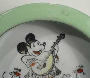 MICKEY MOUSE BOWL - 1930s, a luster lime green rim circle a pie eyed Mickey and friends as he plays a tune